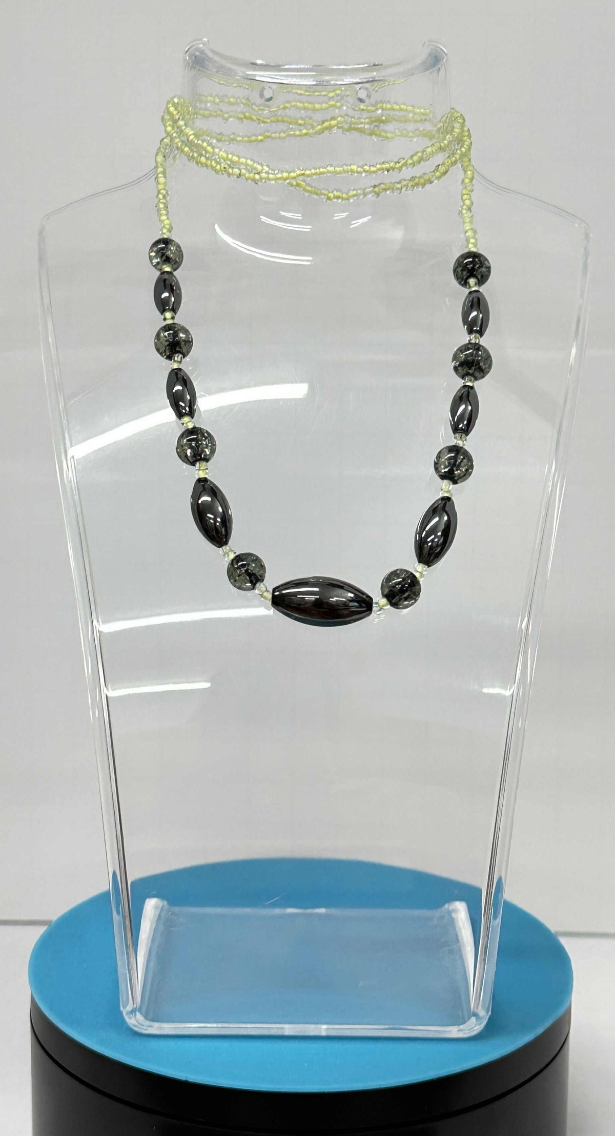 Necklaces Pullover NO Clasp featuring a long strand of glossy black oval beads and fine pale yellow-green seed beads