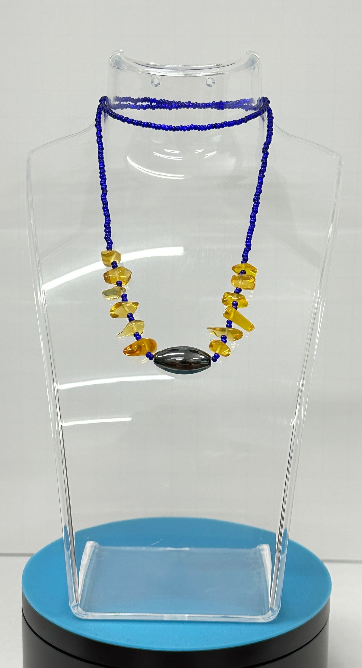 Necklaces Pullover NO Clasp with deep blue seed bead strands, yellow stone chips and a dark oval focal bead